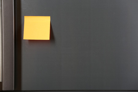 Note on piece of paper on refrigerator closeup