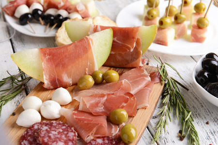 Delicious melon with prosciutto on table close-upの写真素材