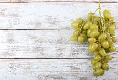 Bunch of ripe grapes on grey wooden backgroundの写真素材