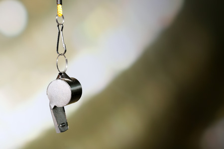 Sport metal whistle on color backgroundの写真素材