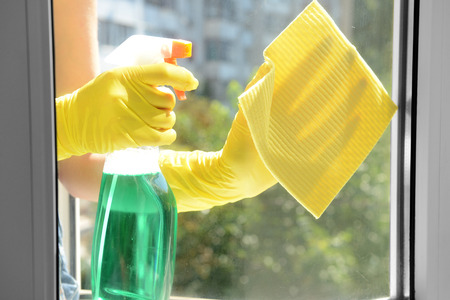 Cleaning windows with special rag and cleaner