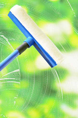 Cleaning windows with special squeegee