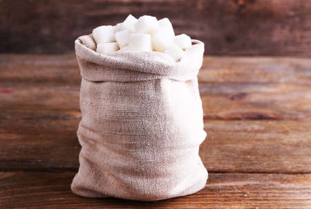 Refined sugar in bag on wooden backgroundの写真素材