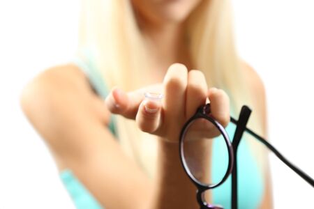 Medicine and vision concept - young woman with contact lens, close upの写真素材