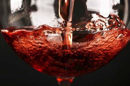 Glass of red wine on dark background closeup Glass of red wine on dark background closeup