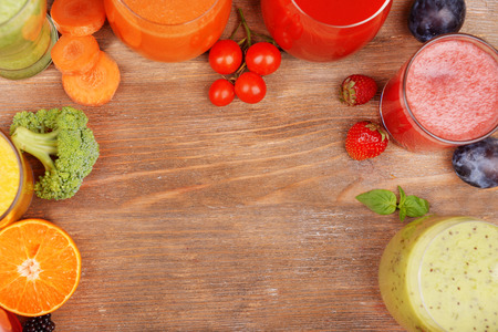 Glasses of tasty fresh juice, on wooden table.の写真素材