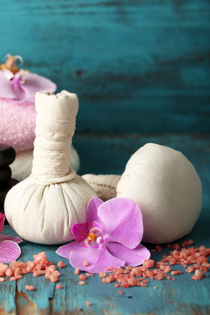 Colorful tropical orchid flowers and spa set on color wooden backgroundの写真素材
