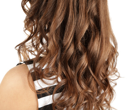 Woman with curly long hair isolated on whiteの写真素材