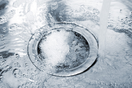 Water flowing down hole in kitchen sink