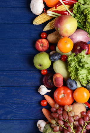 Fresh organic fruits and vegetables on wooden backgroundの写真素材