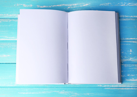 White book on wooden table, close-up