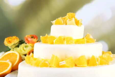 Beautiful wedding cake with oranges on  light backgroundの写真素材