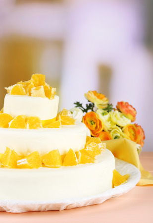 Beautiful wedding cake with oranges on  light backgroundの写真素材