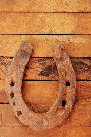 Old horse shoe on wooden backgroundの写真素材