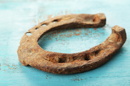 Old horse shoe on wooden background