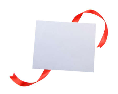 Shiny red ribbon with card isolated on whiteの写真素材