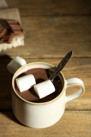 Hot chocolate with marshmallows in mug, on wooden backgroundの写真素材