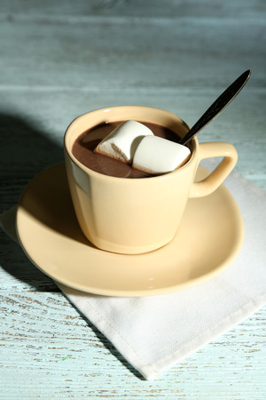 Hot chocolate with marshmallows in mug, on wooden backgroundの写真素材