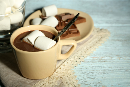 Hot chocolate with marshmallows in mug, on wooden backgroundの写真素材