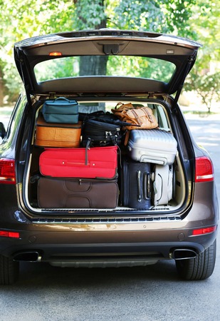 Suitcases and bags in trunk of car ready to depart for holidaysの写真素材