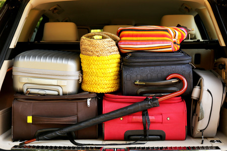 Suitcases and bags in trunk of car ready to depart for holidaysの写真素材