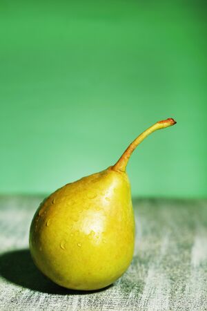 Ripe tasty pear, on wooden tableの写真素材