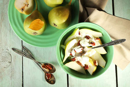 Tasty dessert with pears and fresh pears, on wooden tableの写真素材