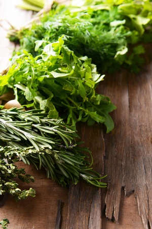 Different fresh herbs on wooden backgroundの写真素材