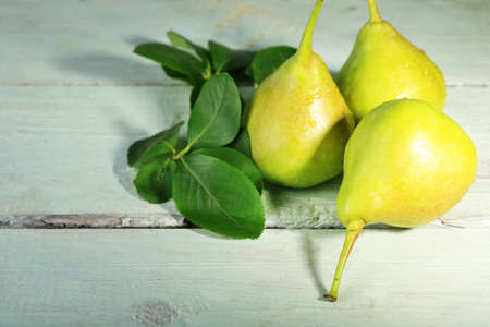Ripe tasty pears, on wooden tableの写真素材