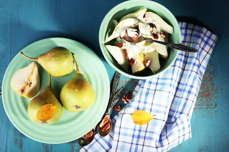 Tasty dessert with pears and fresh pears, on wooden tableの写真素材