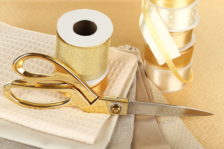 Ribbons with scissors and fabrics close upの写真素材