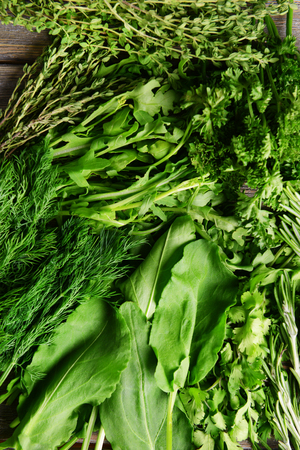 Different fresh herbs on wooden backgroundの写真素材