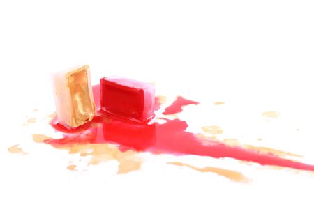 Watercolor paint cube and spilled paint isolated on whiteの写真素材