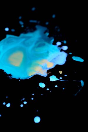 Spilled paint isolated on blackの写真素材