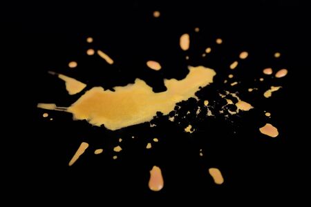 Spilled paint on dark backgroundの写真素材