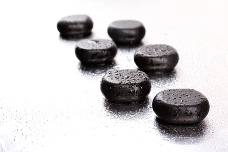 Spa stones with drops on light backgroundの写真素材