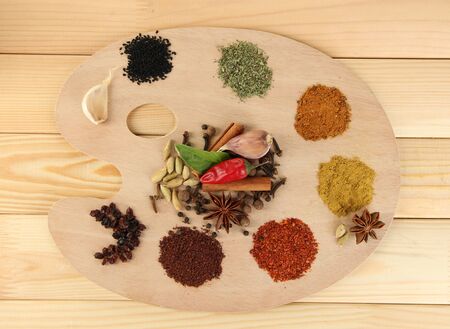 Painting palette with various spices and herbs, on wooden backgroundの写真素材