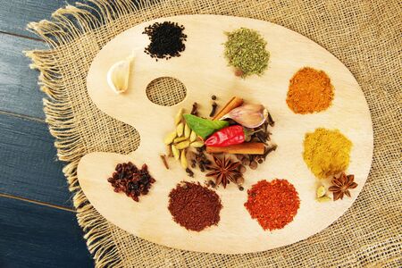 Painting palette with various spices and herbs, on wooden backgroundの写真素材