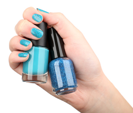 Nail polish in hand, isolated on whiteの写真素材