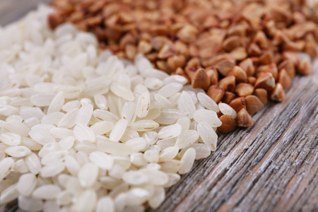 Rice and buckwheat on wooden backgroundの写真素材