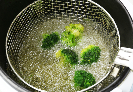 Broccoli in deep fryer, closeupの写真素材