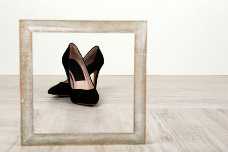 Black women shoes with frame on floorの写真素材