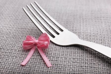 Stages of tying bow on fork, close-upの写真素材