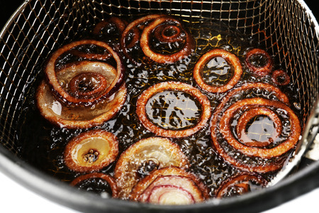 Onion in deep fryer, closeupの写真素材