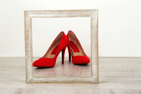 Red women shoes with frame on floorの写真素材