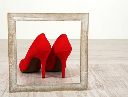 Red women shoes with frame on floorの写真素材