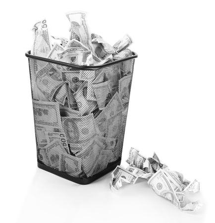 Money in dustbin isolated on whiteの写真素材