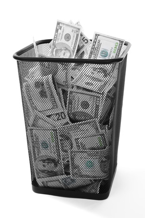 Money in dustbin on grey backgroundの写真素材