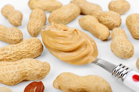 Creamy peanut butter in spoon, close-up