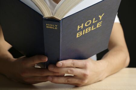 Man reading Bible close up